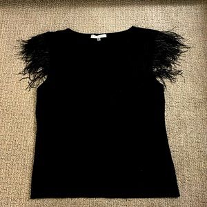 Black sleeveless sweater shirt.  Feathered shoulders.